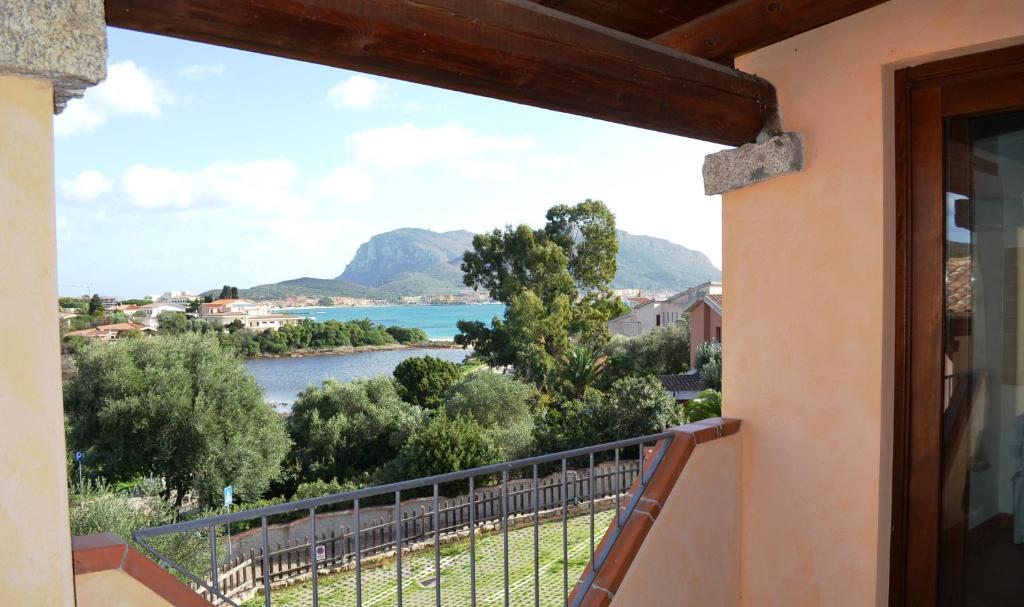 a balcony with a view of a river and mountains at Residence Orizzonti 34 in Golfo Aranci