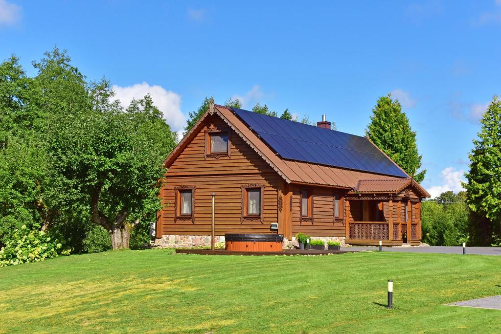 a large wooden house with a large yard at House in Krikstonys in Krikštonys