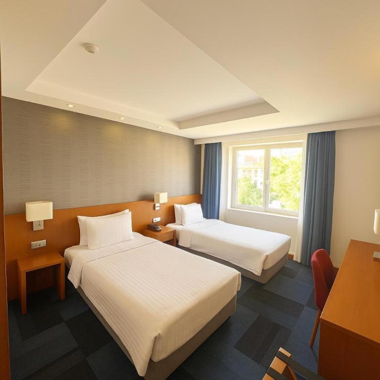 A bed or beds in a room at Taxim Express Bosphorus Hotel