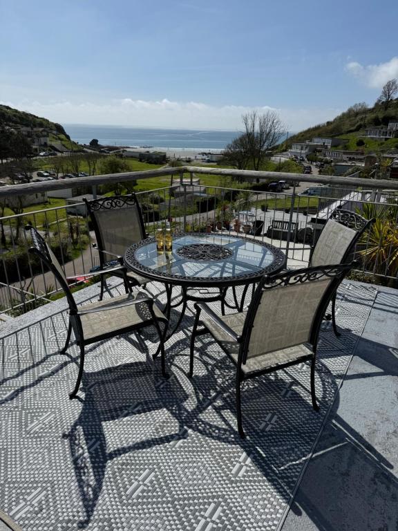a table and chairs on a balcony with the ocean at Shorething in Saint Martin