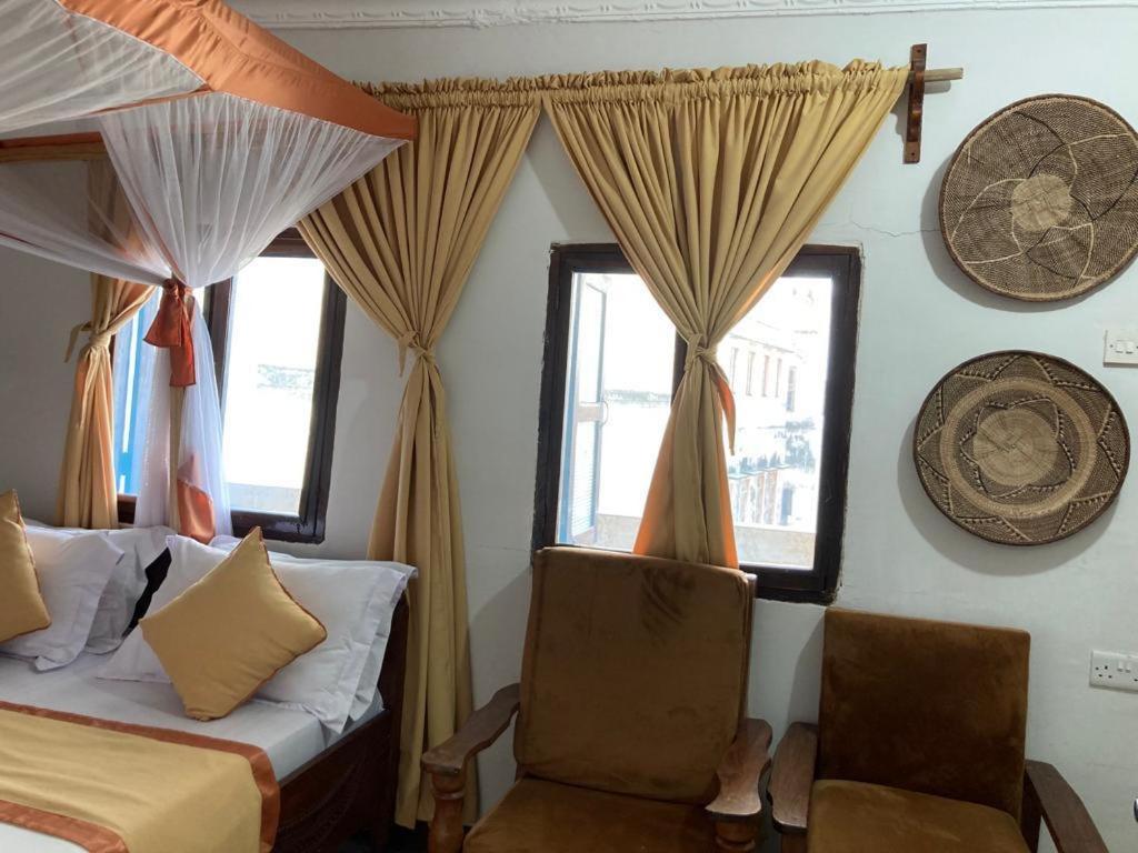 Кровать или кровати в номере Usangi House