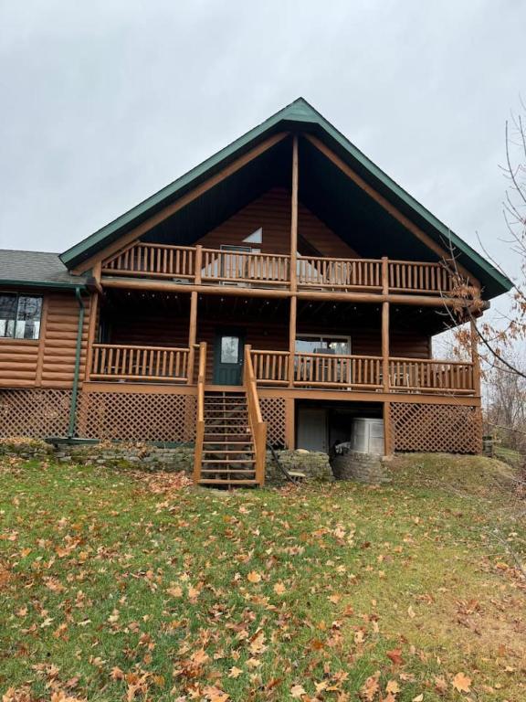 a large wooden house with a large deck at Large Pet-Friendly Family Cabins in Garrison