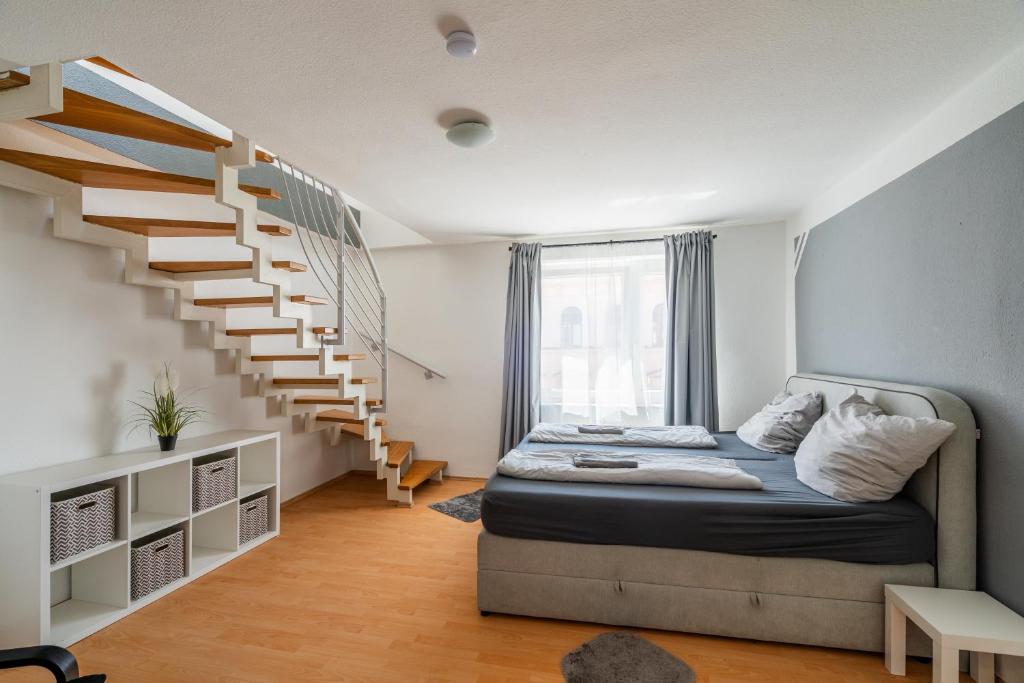 a bedroom with a bed and a staircase at Top-Lage - Top-Wohnung in Leipzig