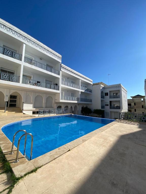 a large apartment building with a large swimming pool at Luxury sea view apt tanger with Swimming pool in Tangier