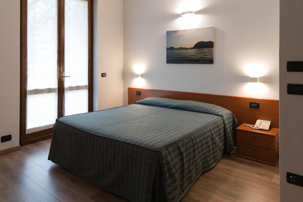 Postel nebo postele na pokoji v ubytování Albergo Ristorante Orazio