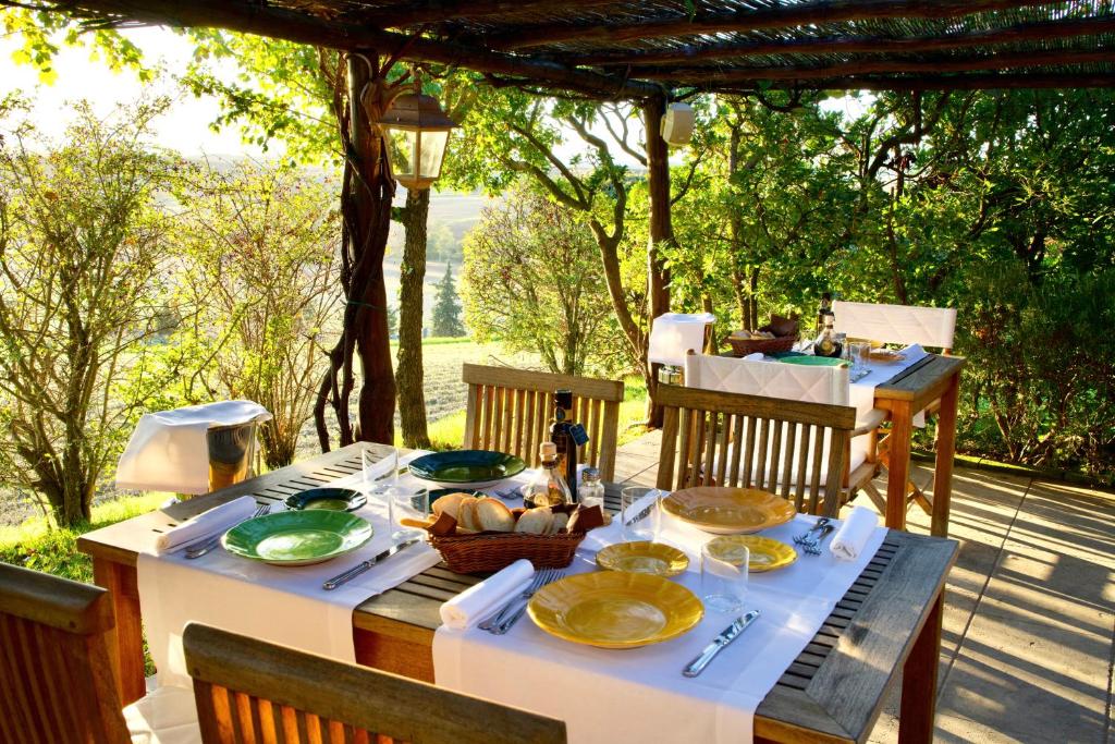 a table with plates of food sitting on a patio at L'Olmo in Monticchiello