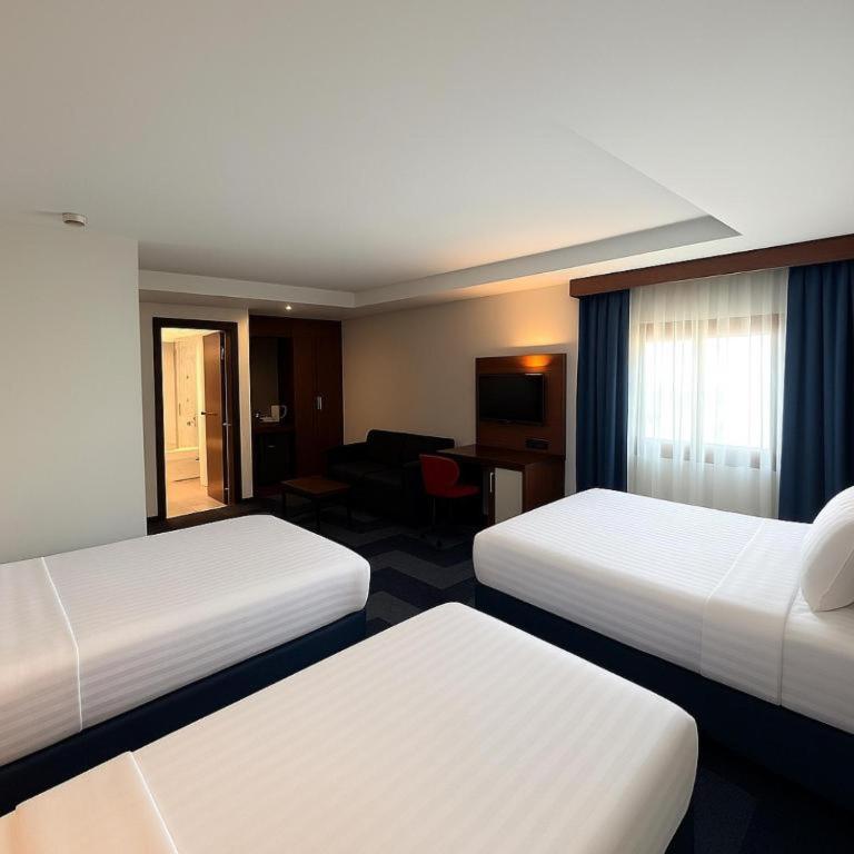 A bed or beds in a room at Taxim Express Bosphorus Hotel
