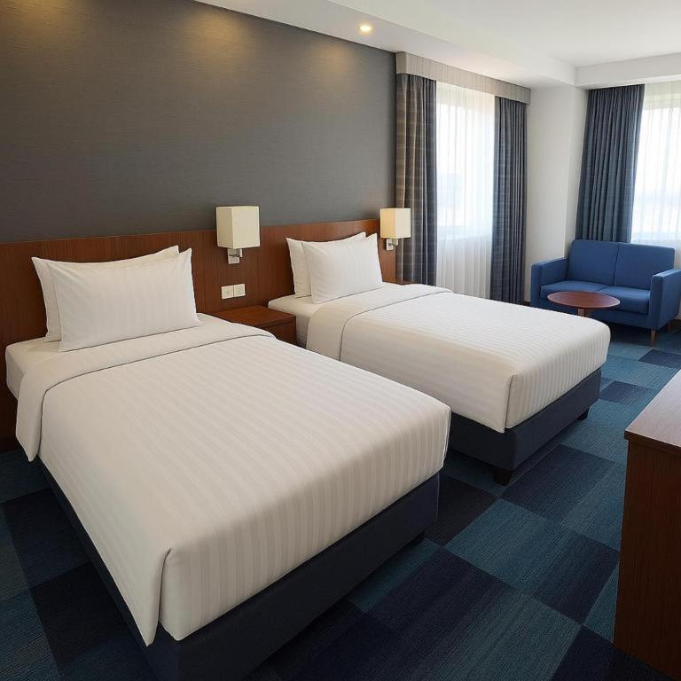 A bed or beds in a room at Taxim Express Bosphorus Hotel