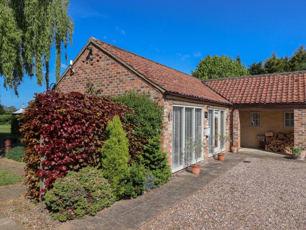 a brick house with a hedge in front of it at Providence Court in York