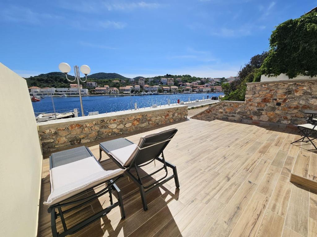 a patio with two chairs and a view of the water at Apartment Lotta in Sali