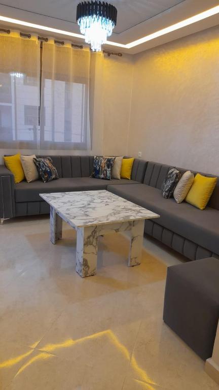 a living room with a couch and a coffee table at Azur et Atlas in Saïdia