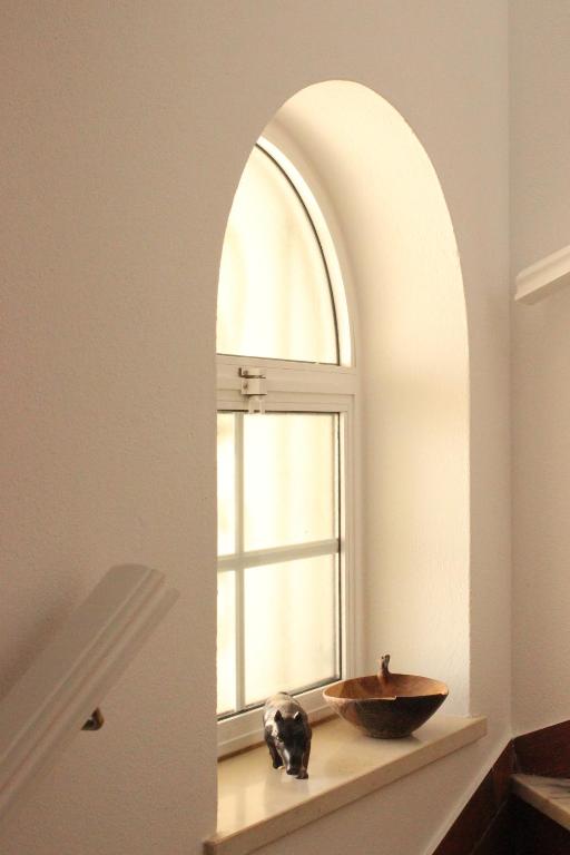 an archway in a bathroom with a sink and a window at Sea View Suite with Pool - Praia da Luz in Luz