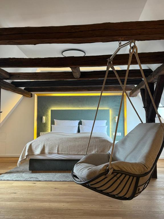 a bedroom with a bed and a swing at Domfreyheit in Naumburg