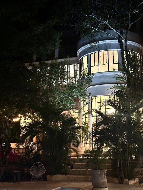 a building at night with trees in front of it at Casa Mag-Ha in Francisco Uh May