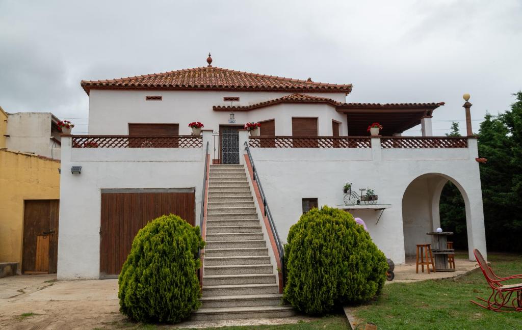 a white house with a gate and stairs at TURISME RURAL HORTA del PI in Cabrera de Mar