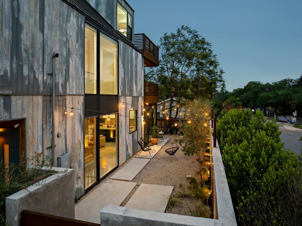 a building with a bench in front of it at Rooftop Deck, DT City Views, Modern Eastside Oasis in Austin