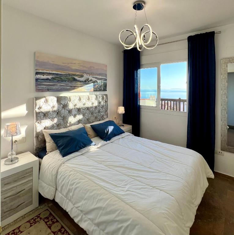 A bed or beds in a room at Beachfront Penthouse Apartment with Large Terrace and Breathtaking Sea Views close to Marbella Spain