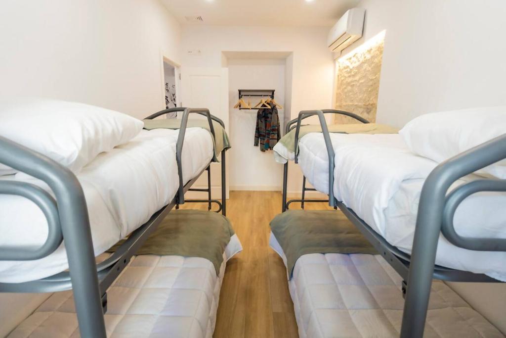 Postel nebo postele na pokoji v ubytování Apartamentos La Cruz Verde
