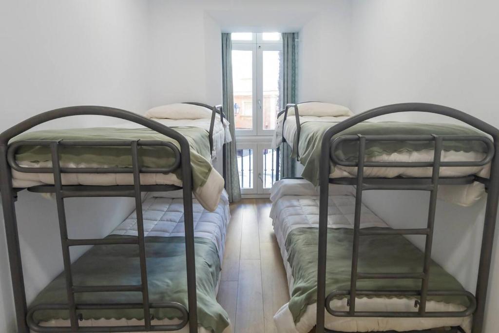 Postel nebo postele na pokoji v ubytování Apartamentos La Cruz Verde
