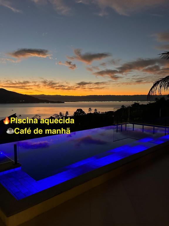 a view of the sunset from the roof of a building at Maluhia Ilhabela 5 in Ilhabela