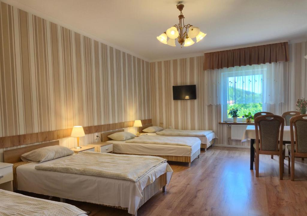 Postel nebo postele na pokoji v ubytování Dom Gościnny BIEGUN