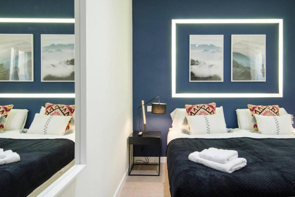 A bed or beds in a room at Minty Stay - 3 BD Lavapies