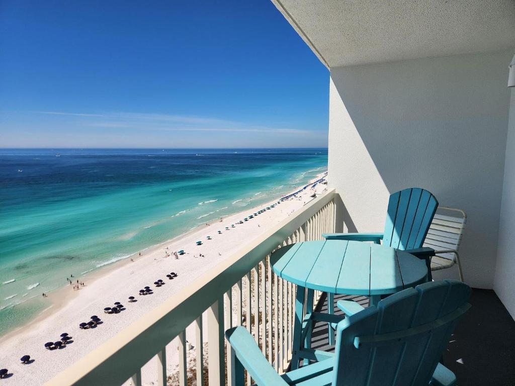 a balcony with a view of the beach and ocean at Pelican Beach Resort Top 20th Floor Condos with Ocean View in Destin
