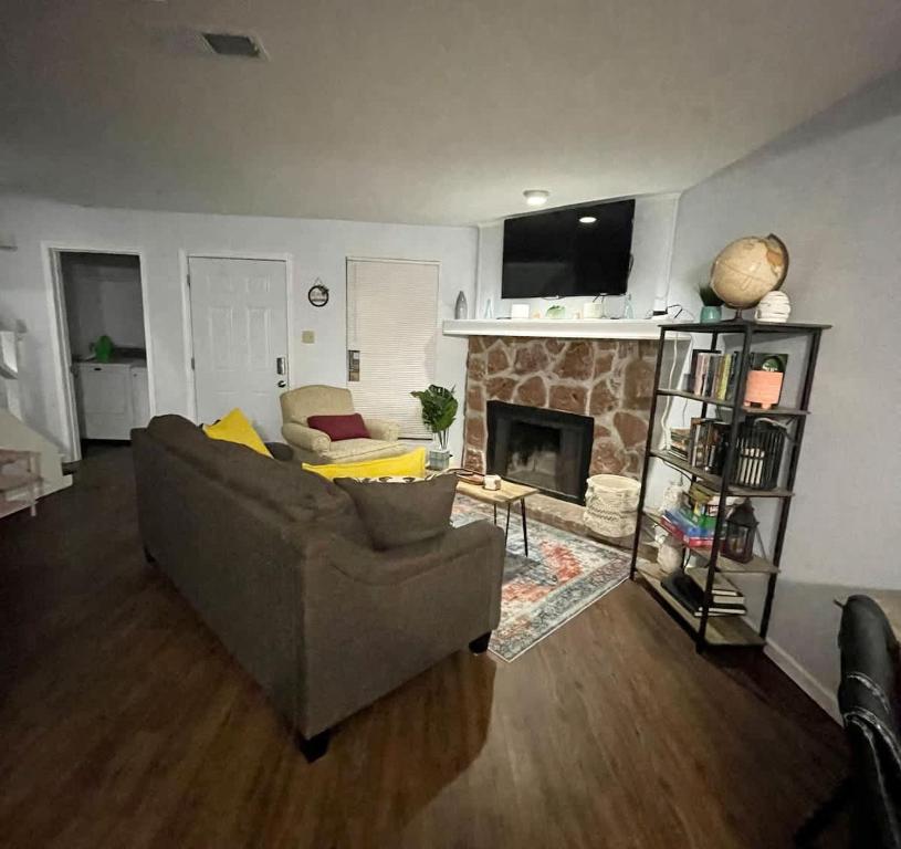 a living room with a couch and a fireplace at Cozy 2BR 2BA apt close to Siegen & Womans in Baton Rouge