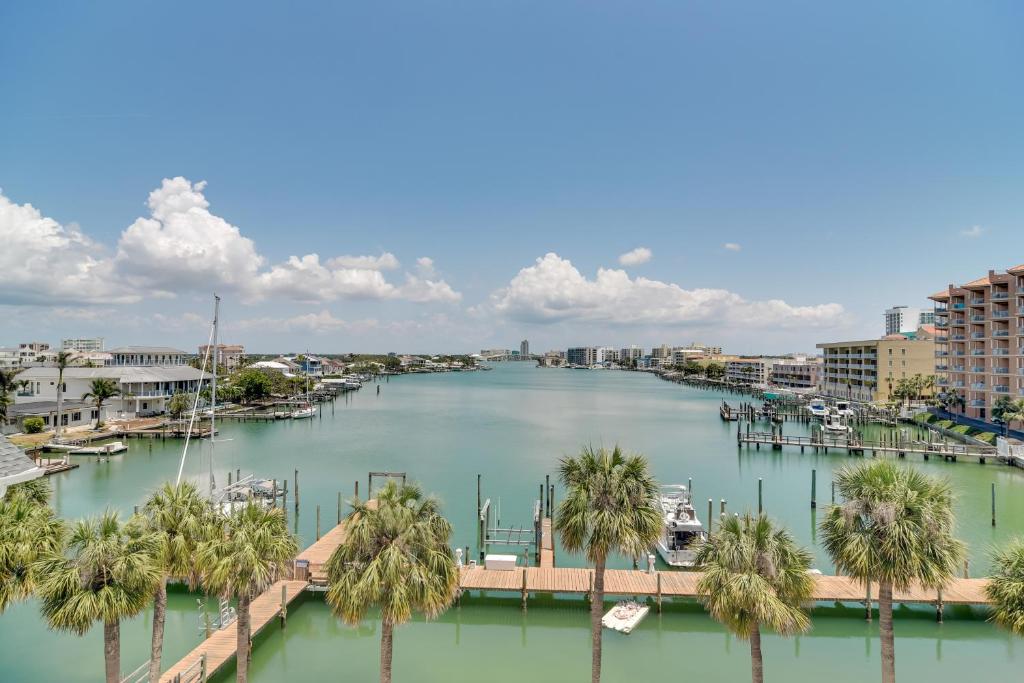 a river with palm trees and a marina with boats at Condo Across From Clearwater Beach Boardwalk in Clearwater Beach