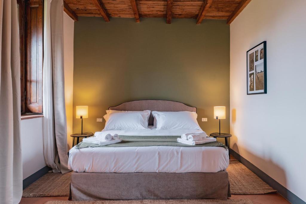 Postel nebo postele na pokoji v ubytování Relais Macconago