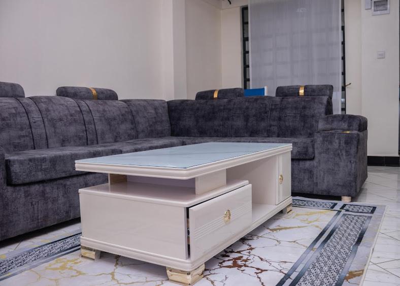 a living room with a couch and a coffee table at Nanyuki Modern 1 Bedroom in Nanyuki
