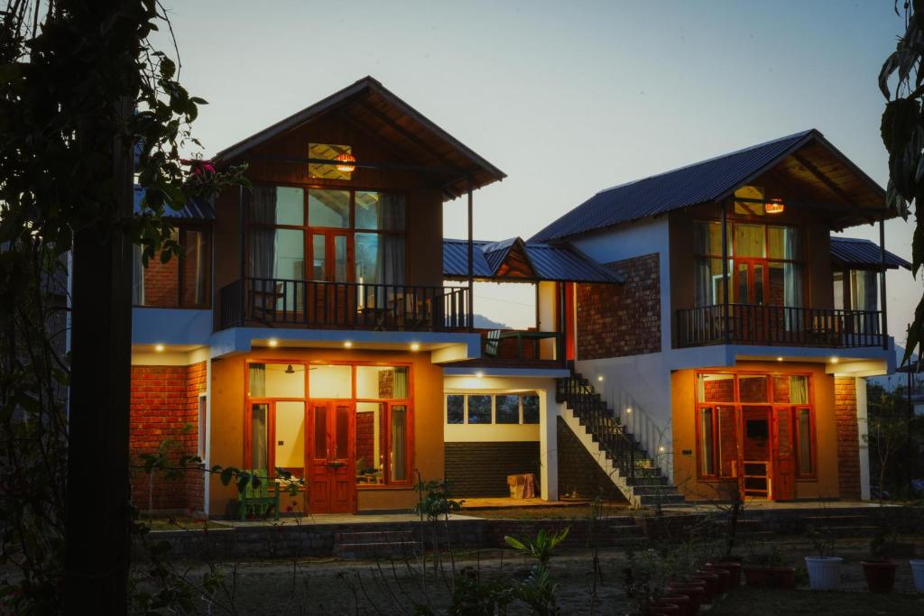 a large house with red doors and windows at Ethnic Trail Homestay in Bhīm Tāl