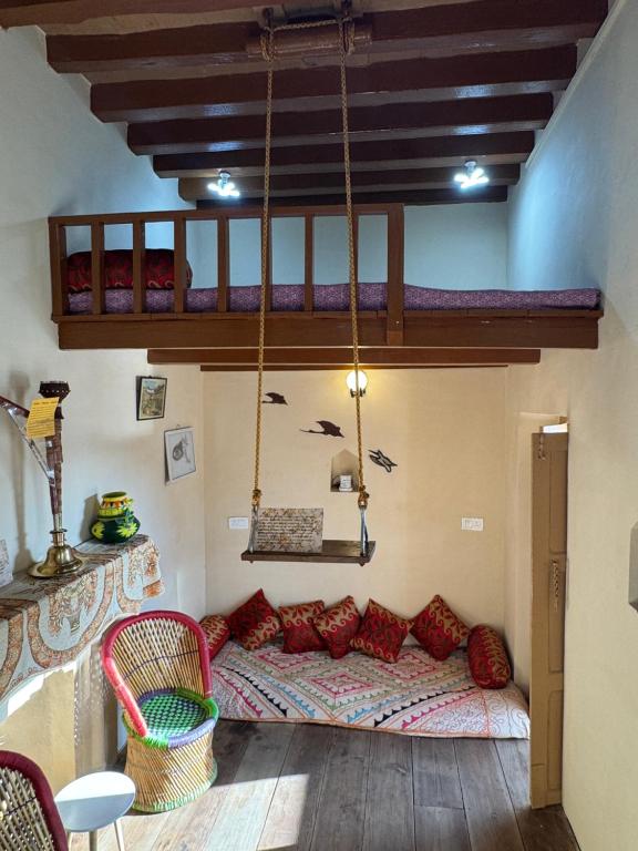 a room with a couch and a hanging bed at Landour Apartment Beauty and Charm Kothri- Vintage Vibes in Mussoorie