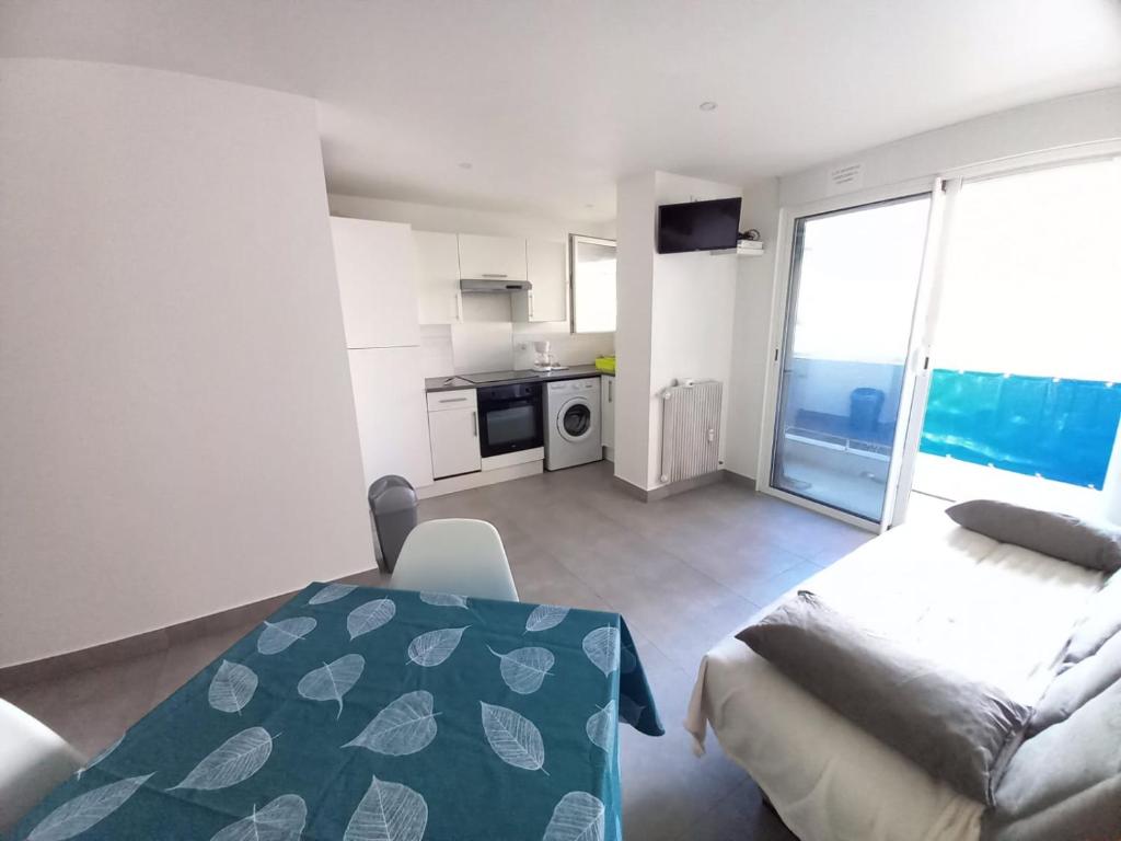 Cette chambre comprend un lit, un canapé et une cuisine. dans l'établissement T2 à côté de la plage, à Antibes