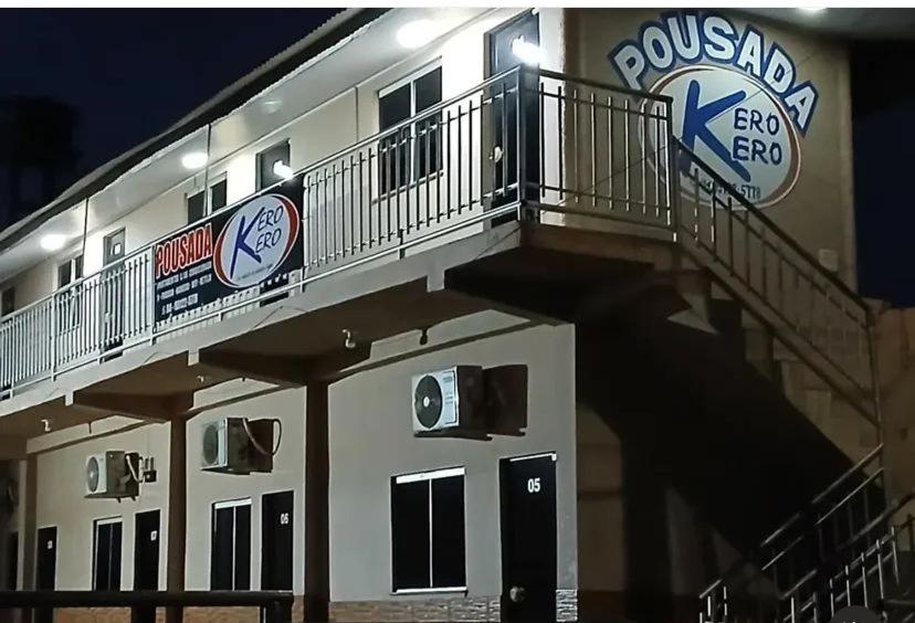 a building with a balcony with a clock on it at Pousada e Restaurante Kero Kero in Conceição do Araguaia