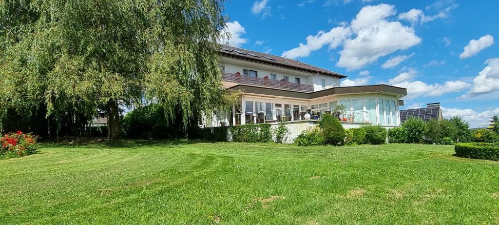 a house with a large yard in front of it at Hotel Sonnenhof in Lügde