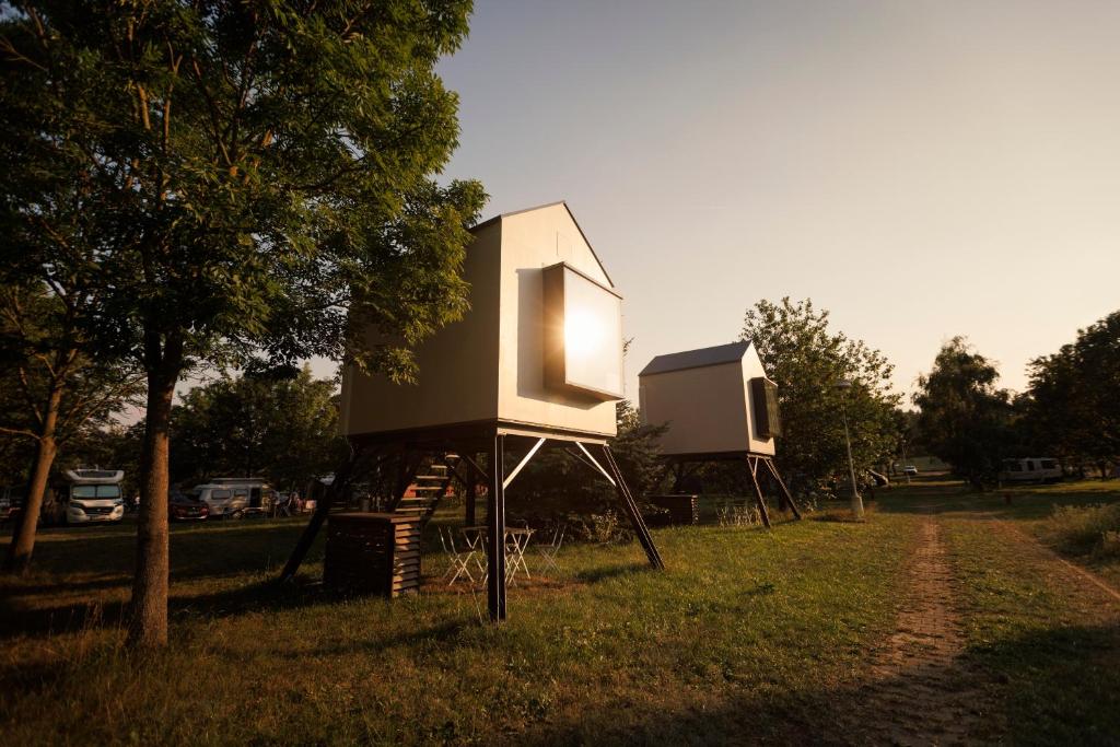 a couple of houses sitting in the grass at Prague Camping Dzban in Prague