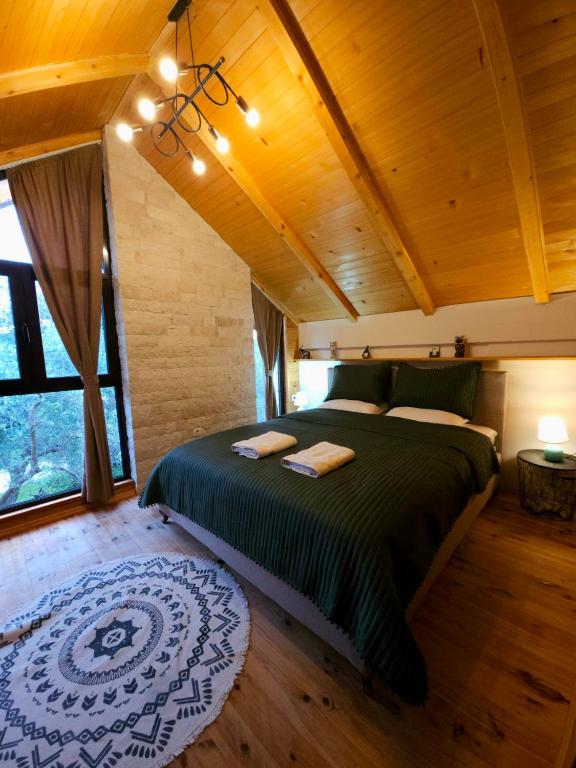 a bedroom in a tree house with a large bed at OLEA COTTAGE in Ulcinj