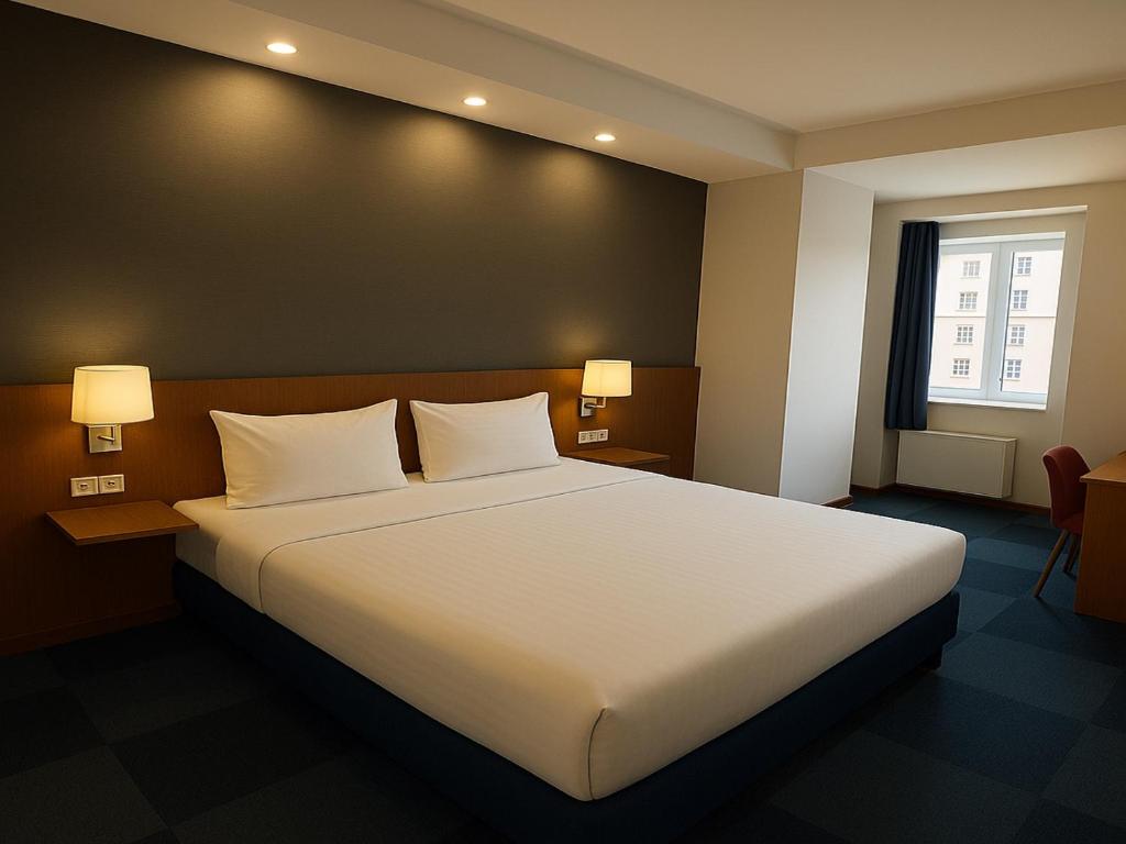 A bed or beds in a room at Taxim Express Bosphorus Hotel