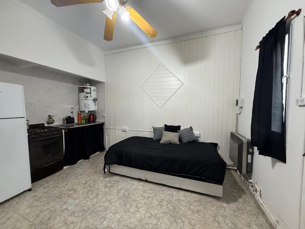 a bedroom with a bed and a ceiling fan at Departamento in Mar del Plata