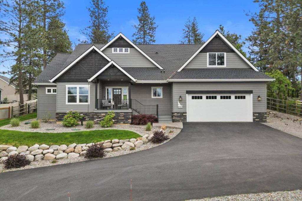 a gray house with a white garage at Winston's Luxurious Retreat in Coeur d'Alene