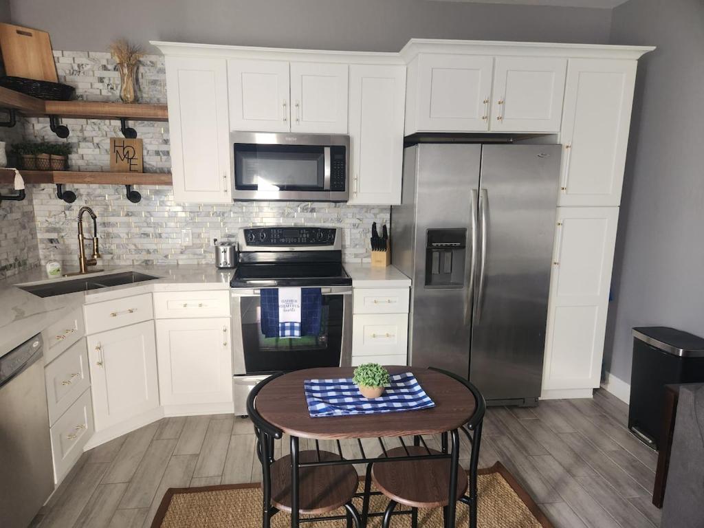 a kitchen with a table and a stainless steel refrigerator at Modern Apartment in The Groves in Mesa