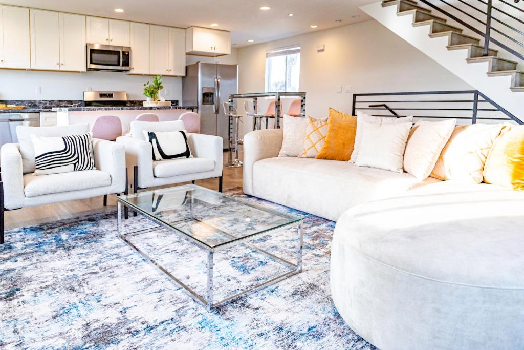 a living room with white couches and a glass table at Modern 5-bedroom House FREE parking in Los Angeles