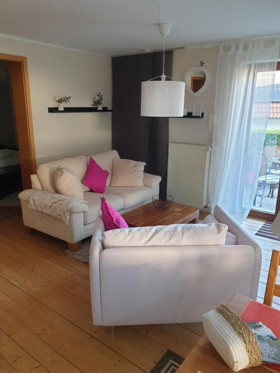 a living room with a white couch and a table at Traumpfade II in Boppard