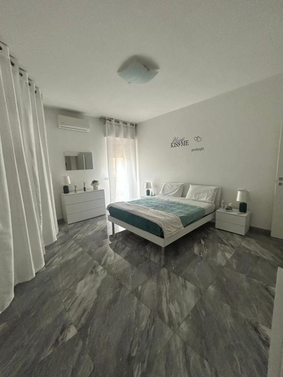 a white bedroom with a bed and a window at Arcola -La Spezia-cinque terre-Lerici in Arcola