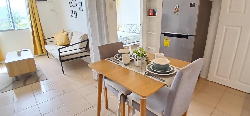 a kitchen and dining room with a table and chairs at Mike's Place at Marina Spatial in Dumaguete
