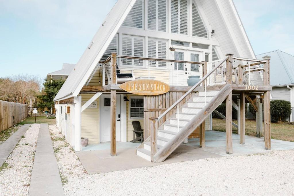 a house with a staircase in front of it at The Little Ray - 2 blocks to Beach - Backyard - Walk to Boardwalk in Carolina Beach