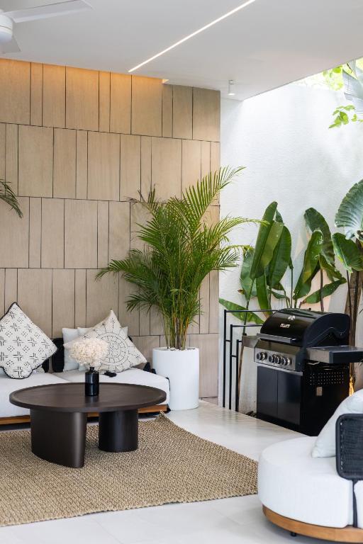 a living room with a table and some plants at Archestet Villas Canggu in Canggu