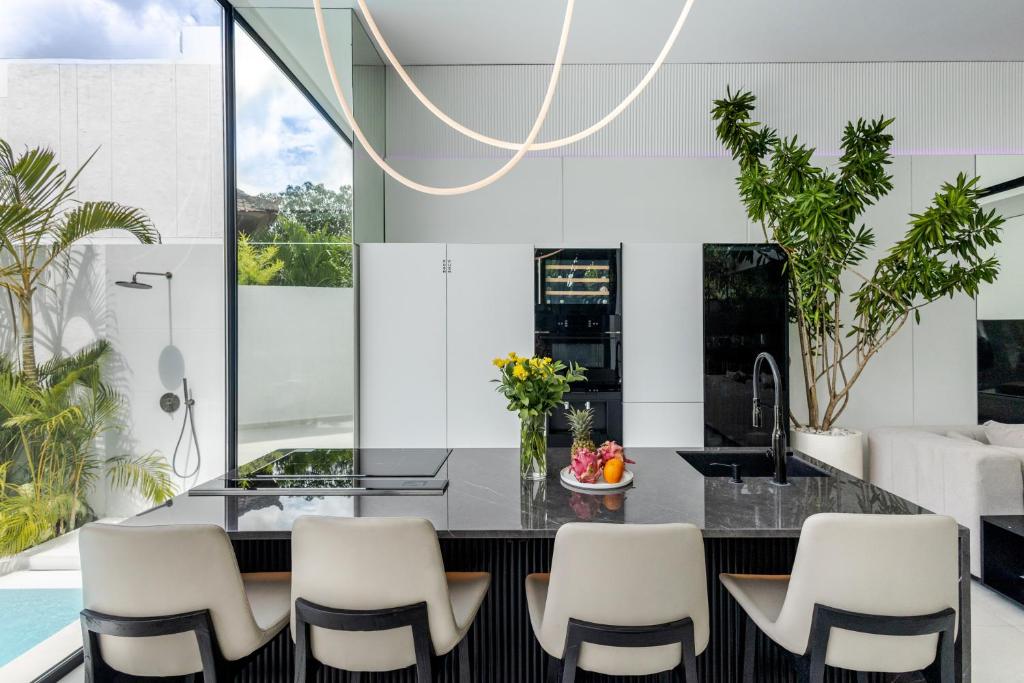 a kitchen with a dining table and chairs at Archestet Villas Canggu in Canggu