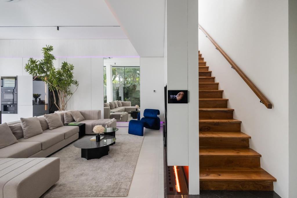 a living room with a couch and a staircase at Archestet Villas Canggu in Canggu